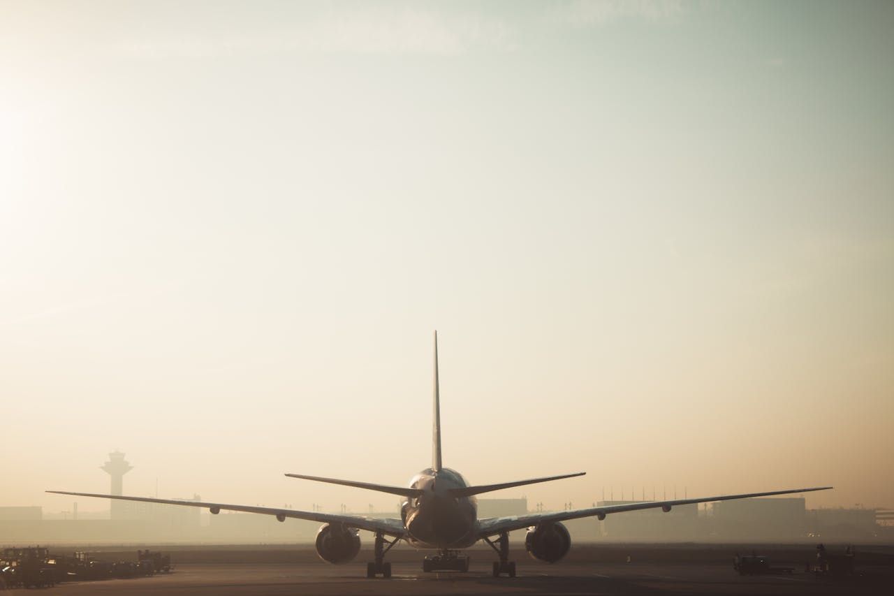 Mastering the First Impression: Your intriguing post title goes here A misty morning scene of a plane on the runway with a hazy sky background, showcasing air travel ambiance.